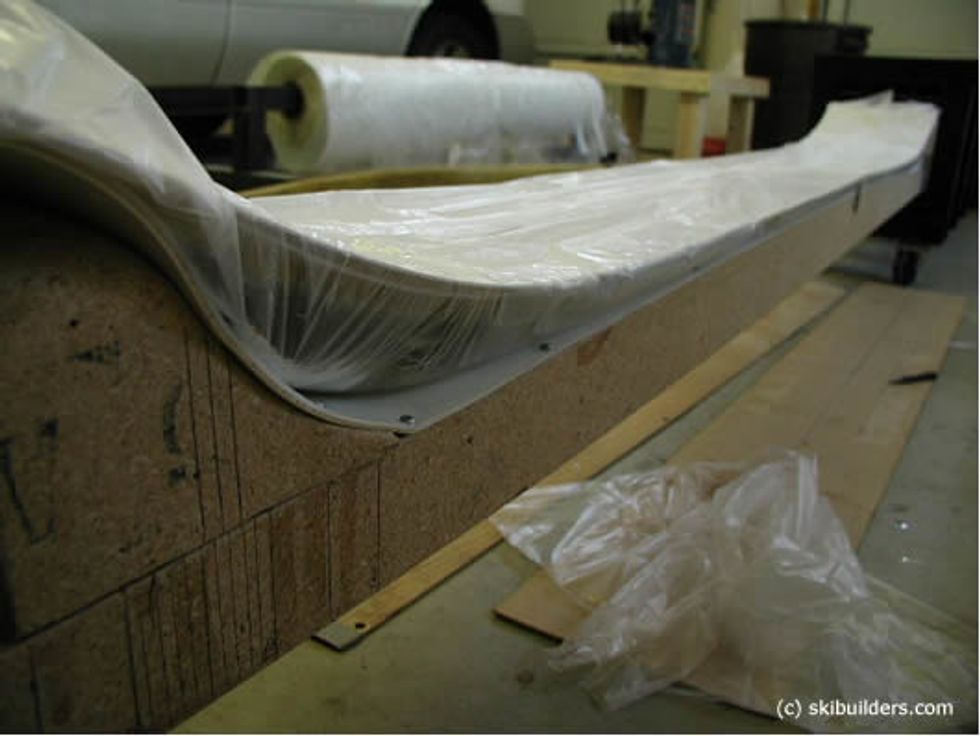 Seal the plastic sheet on the mold so that it is air tight around the ski