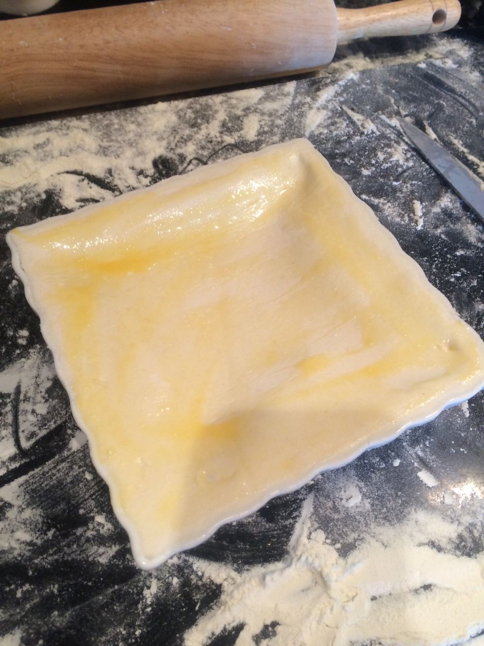 Seal the top to the base and brush over with the egg wash. Prick the top and add a design with any left over pastry if you have any.