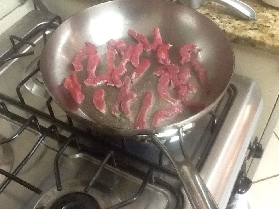 Sear strips of meat on both sides.