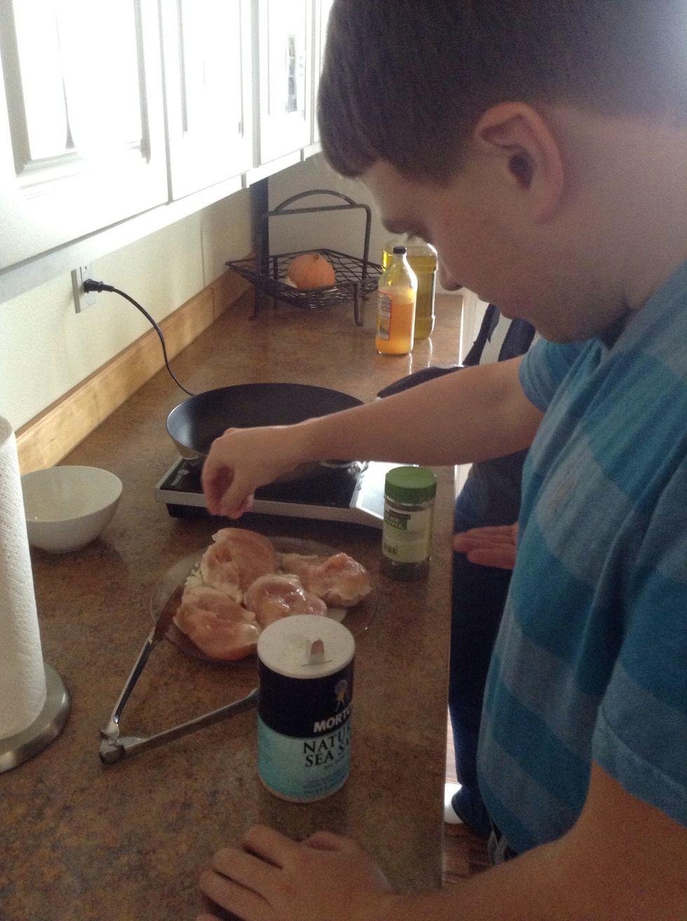 Season chicken with salt and pepper