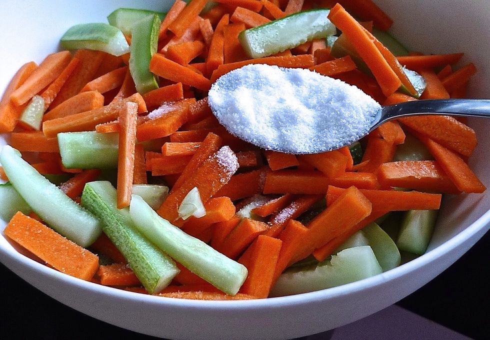 Season cucumber and carrot strips with 1 tablespoon salt for 20-30 minutes.