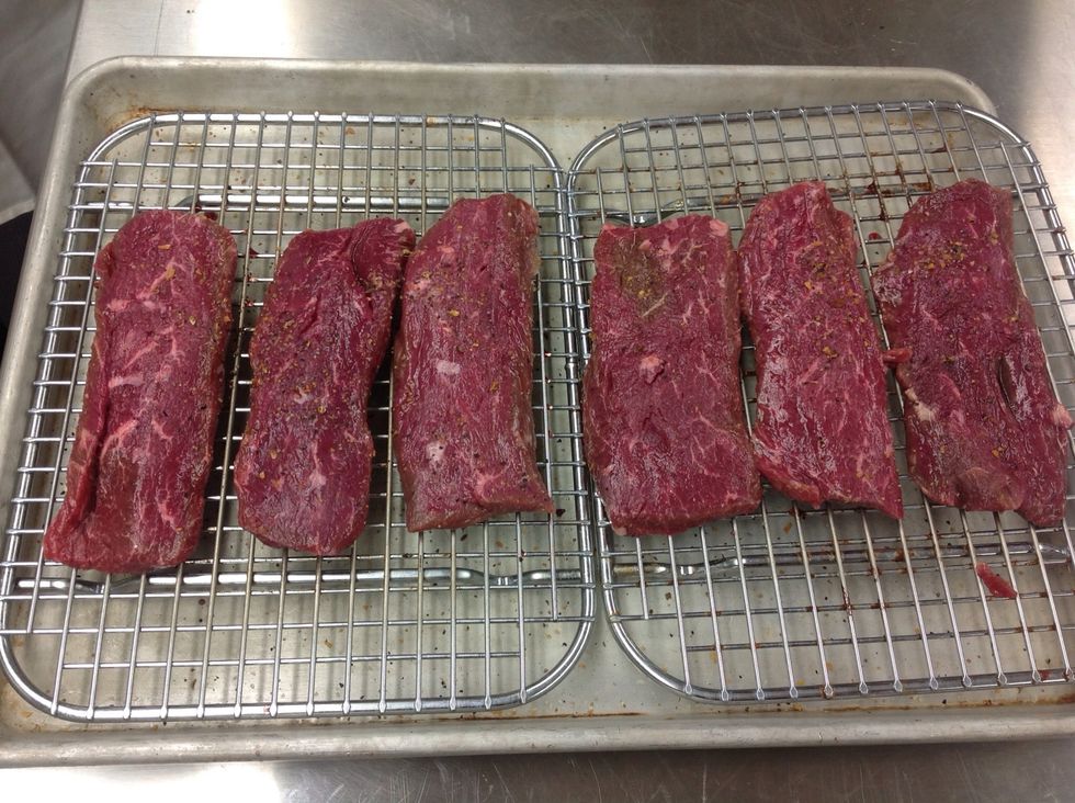 Season lamb loins and place on icing rack