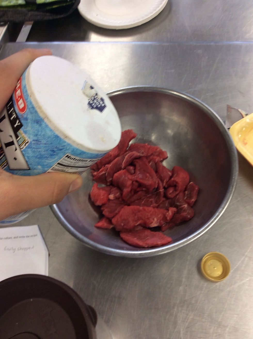 Season meat with salt, pepper, and adobo seasoning
