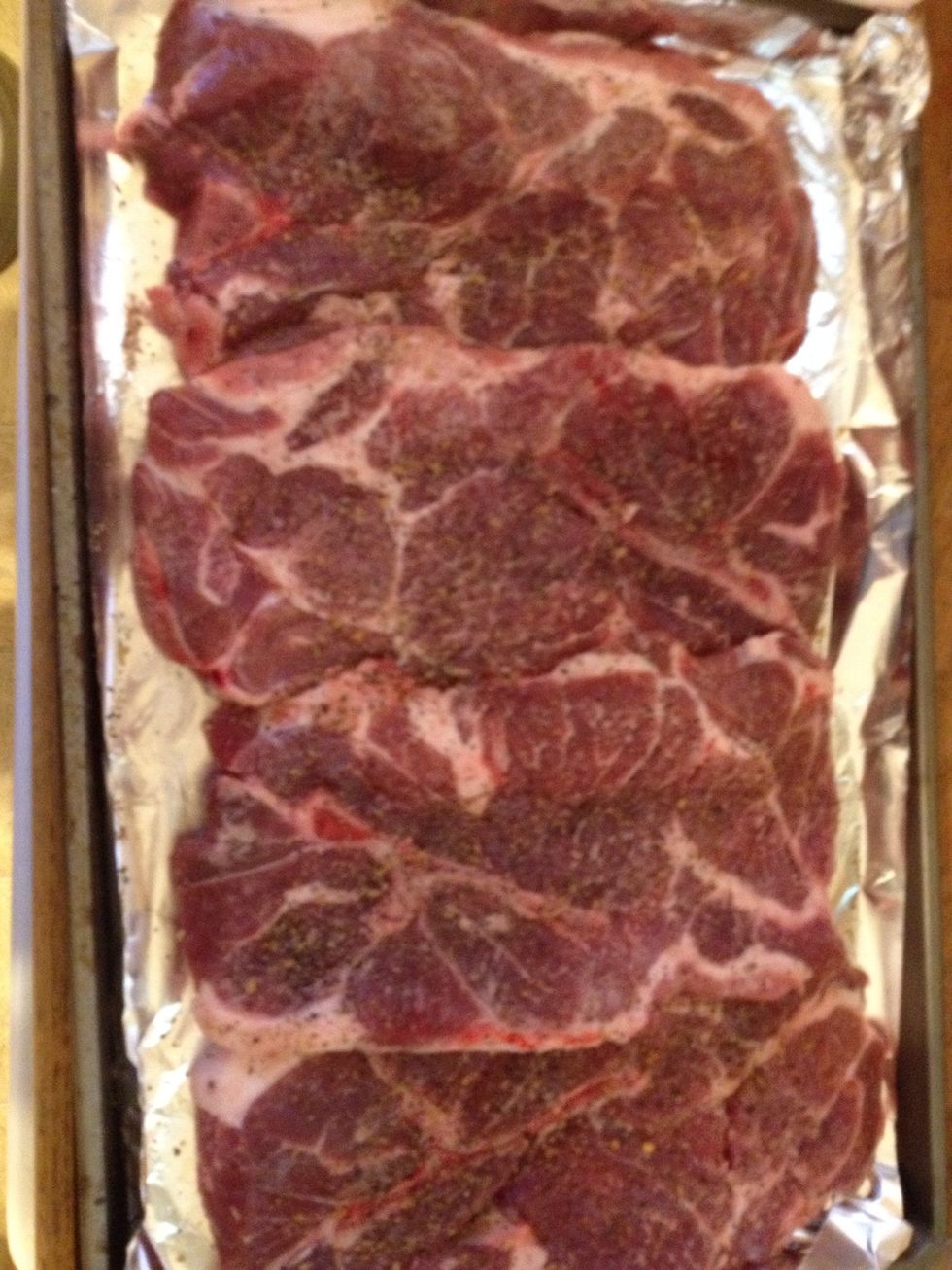 Season pork steaks with your choice of seasoning. I use montreal steak seasonings and onion powder.