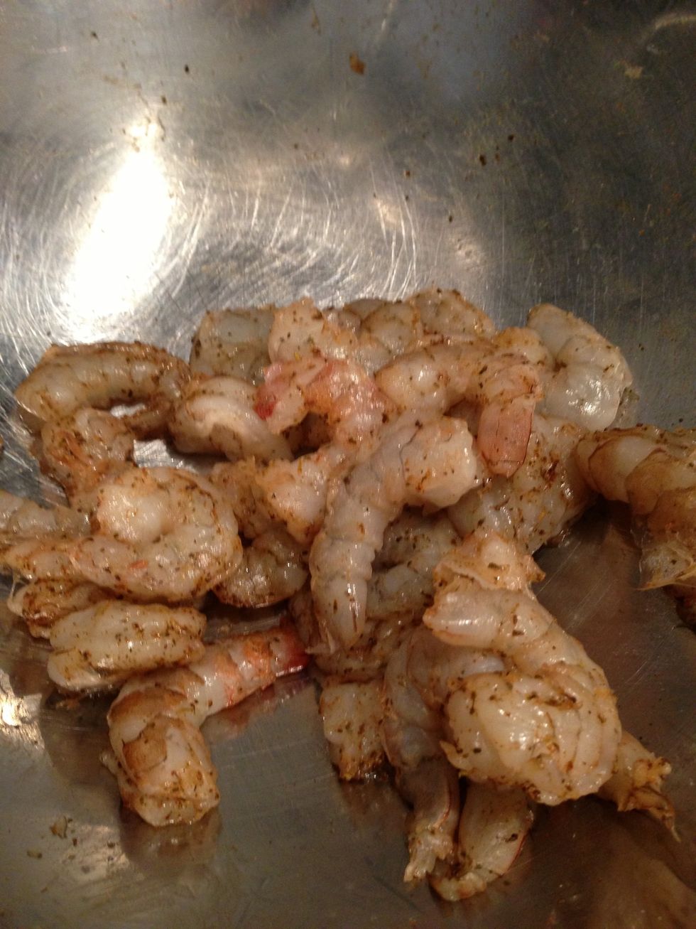 Season shrimp with Cajun spices