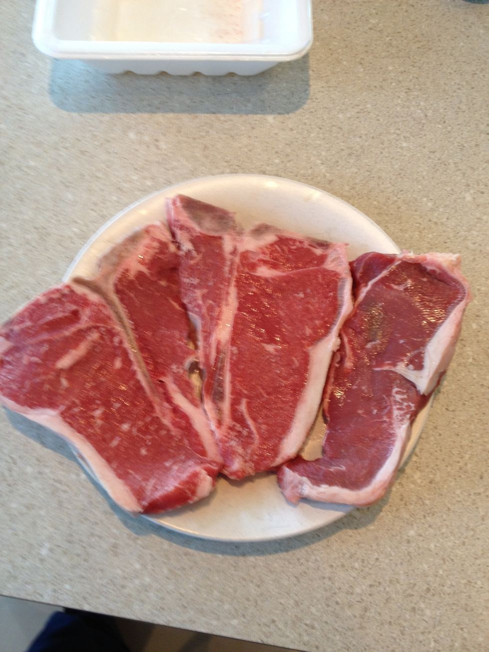 Season steaks to your liking then let them sit at room temperature for at least twenty minutes. Never put a cold steak on the grill.