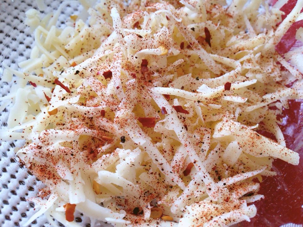 Season the cheese with a bit of ground chili powder, chili flakes and pepper.