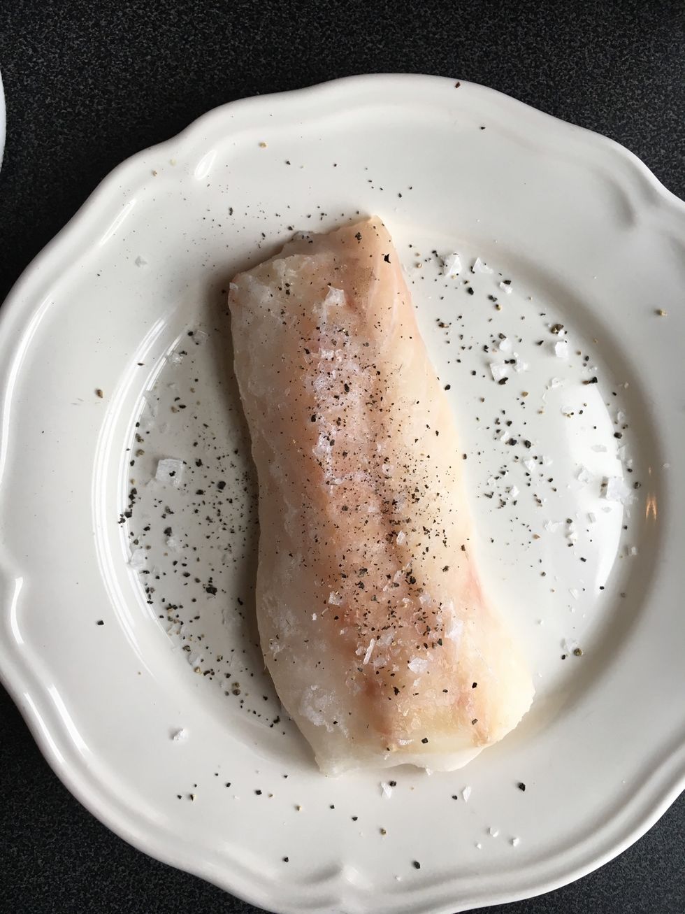 Season the fish filet with a pinch of salt and pepper on each side