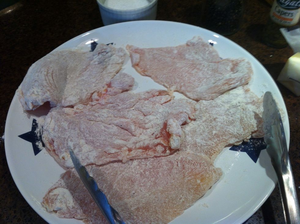 Season the flour with salt and pepper, then cost the chicken