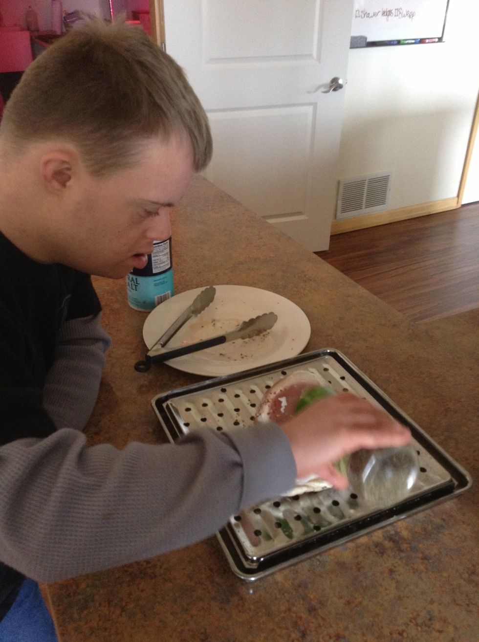 Season top side of chicken with salt, pepper, and red pepper flakes