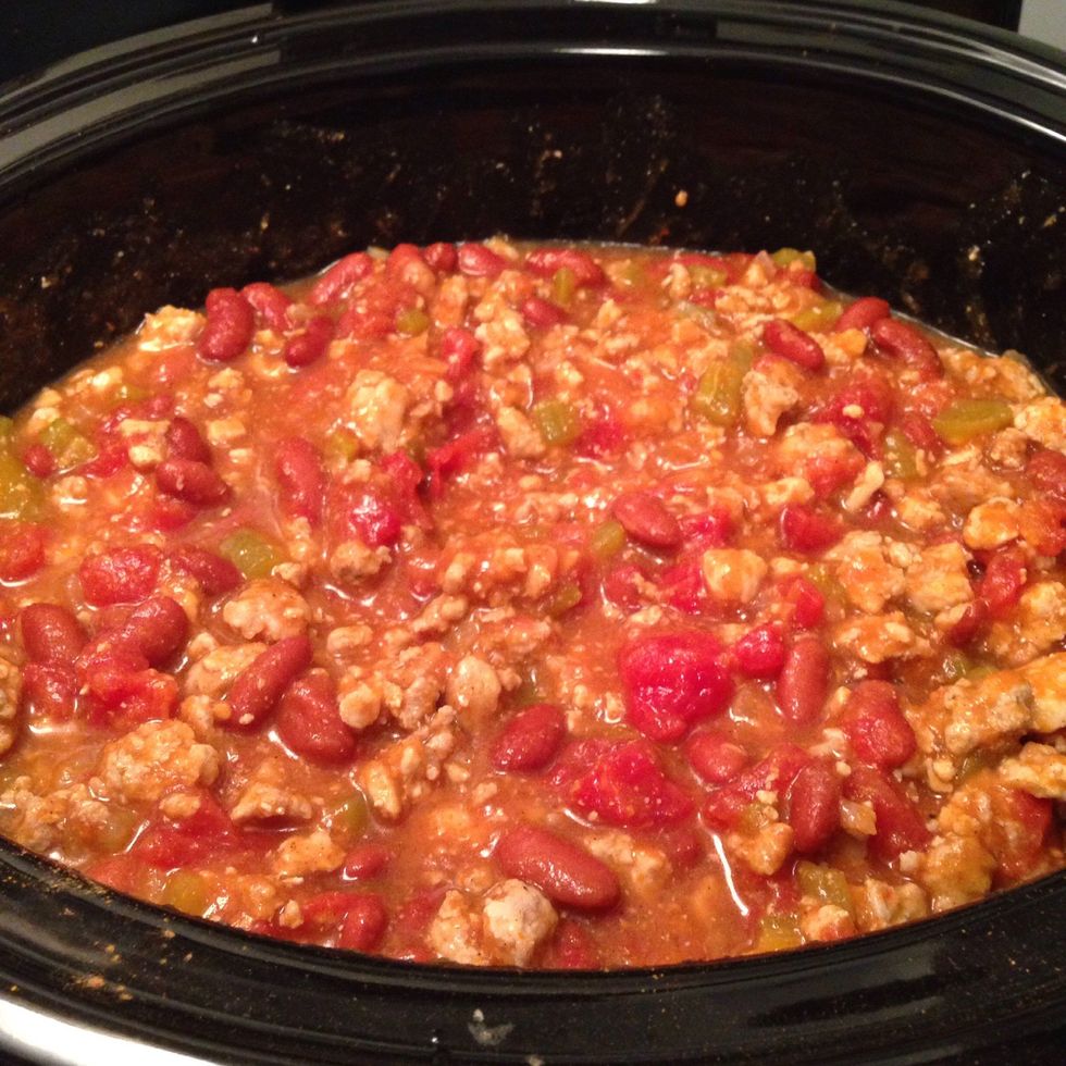 Season with pumpkin pie spice & chili powder. If you like a hotter chili, add red pepper flakes or cayenne pepper too. Stir everything to combine all the ingredients & seasoning.