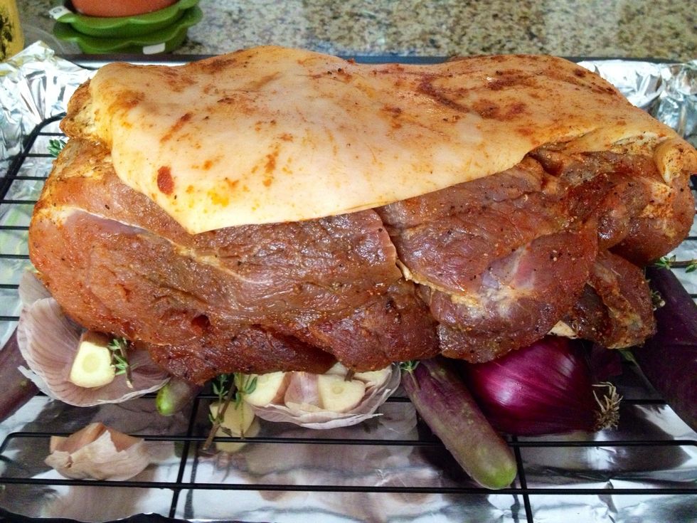 Seasoned pork on top of garlic, aubergine, onions, and thyme.