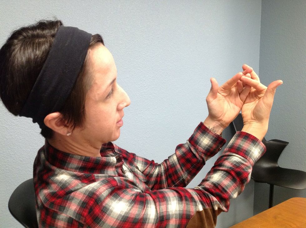 Second, cross your ring fingers above your pinky's