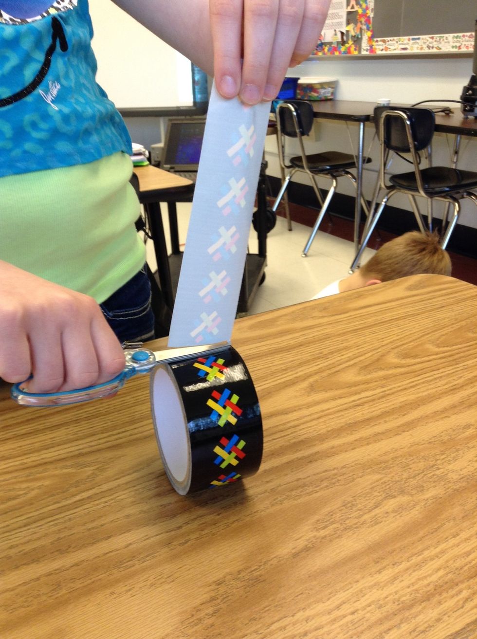 Second, cut a strip of duct tape about an inch long.