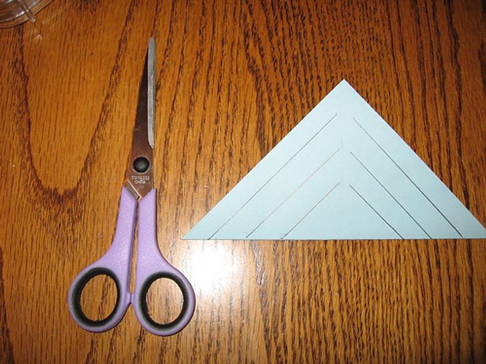 Second cut up from where you folded the paper into a triangle. Do the exact same cut on the other side as shown in the picture.