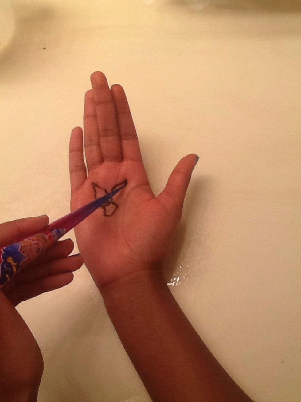 Second, draw the petals. Make the bottom part the petals wide and get narrower towards the tip. Draw 5 circles around the circle.