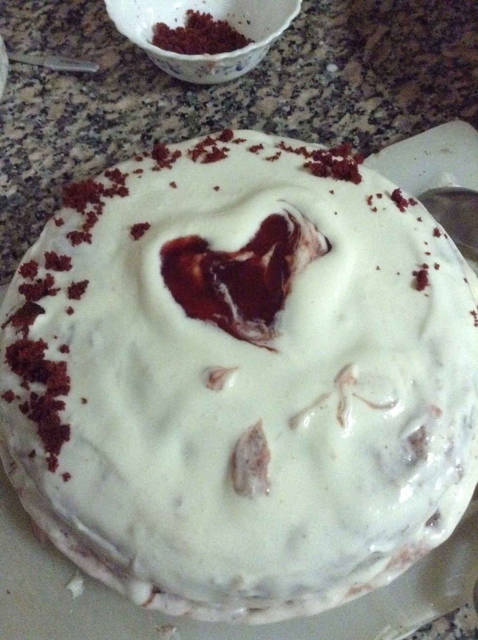 Second layer covered with frosting and by using homemade fresh strawberry jelly I made heart :) and cake crumbs for decoration