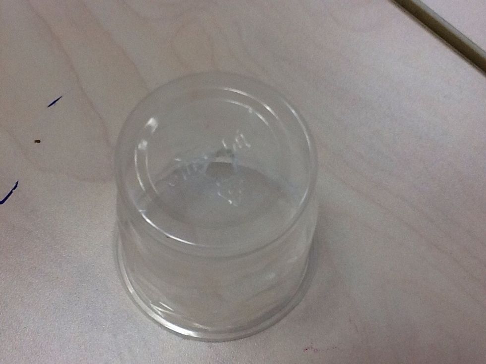 Second,make a hole on the bottom of the plastic cup.