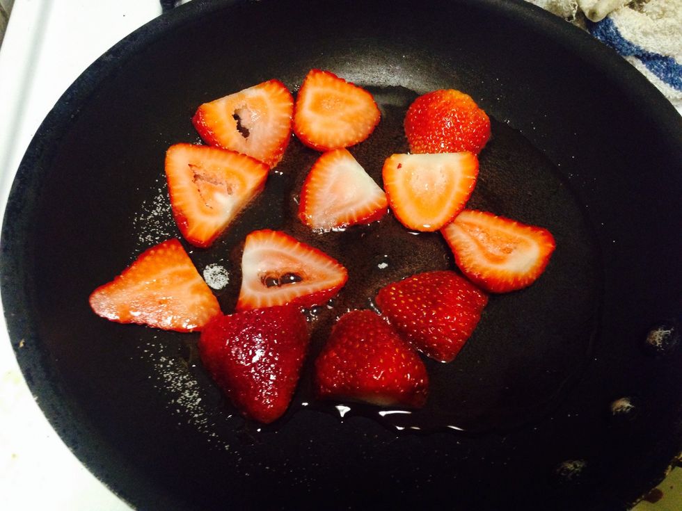 Second place strawberries in a pan to heat a bit with a little bit of water and sugar so they can get caramalized