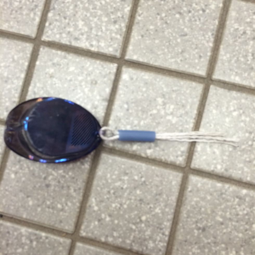 Second, push both ends of the string through the nose piece.