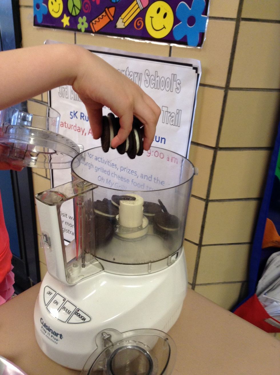 Second, set up food processor. Next, put Oreos in.