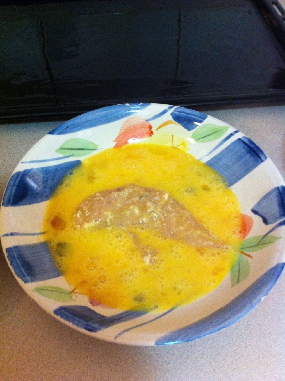 Second step: Dip the floured chicken in the egg mixture.