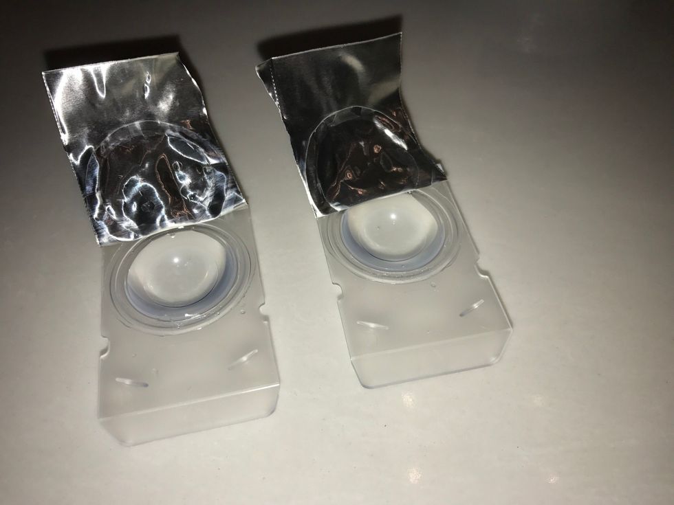 Second take out a pair of contacts and open them up.