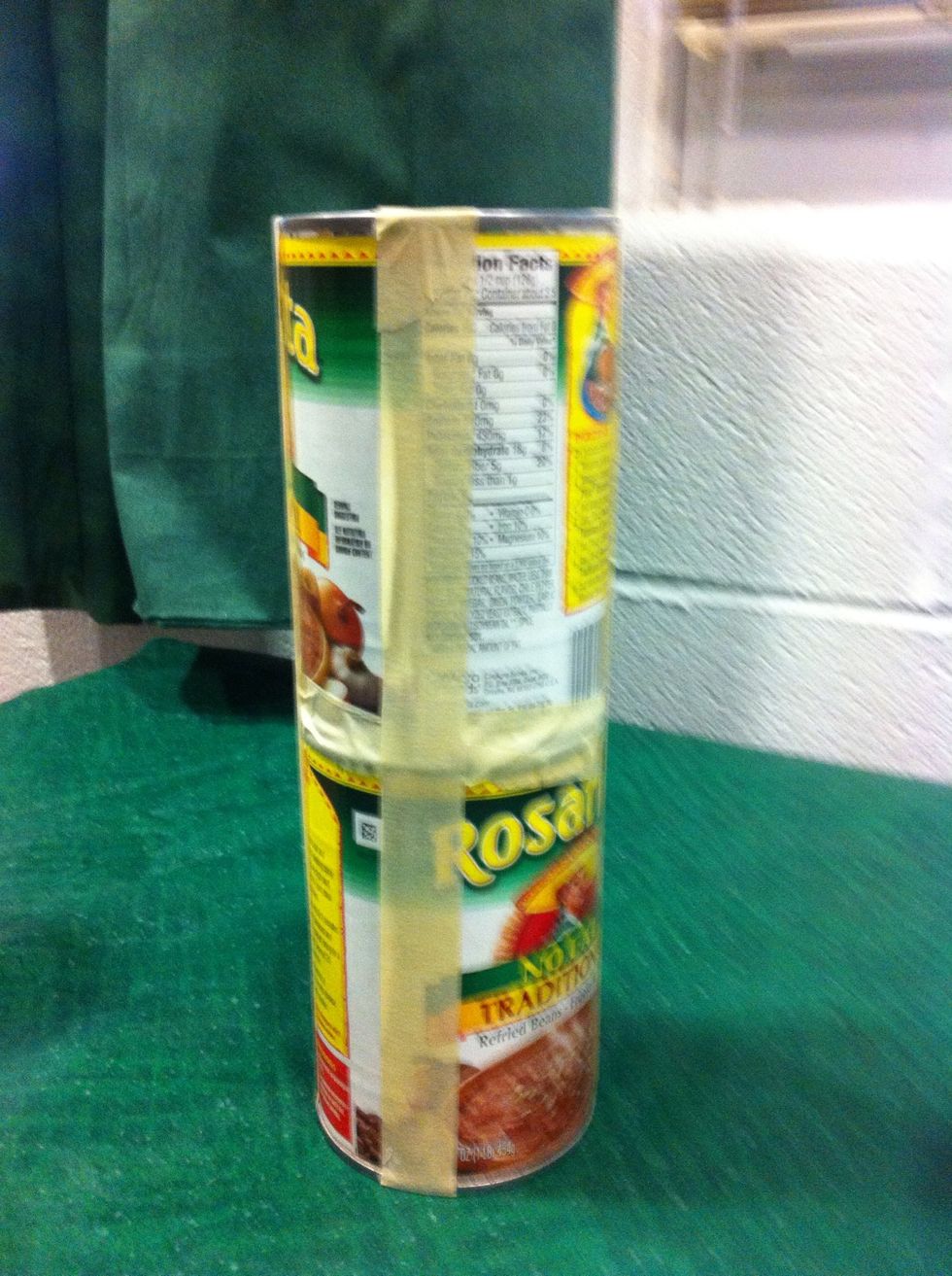SECOND. Tape two cans securely together. Make enough pairs to support the "top row" of your bleachers.