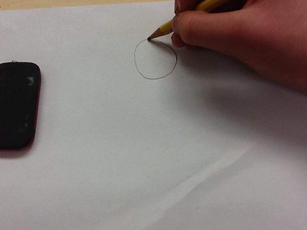 Second you draw a head at the top of the paper.