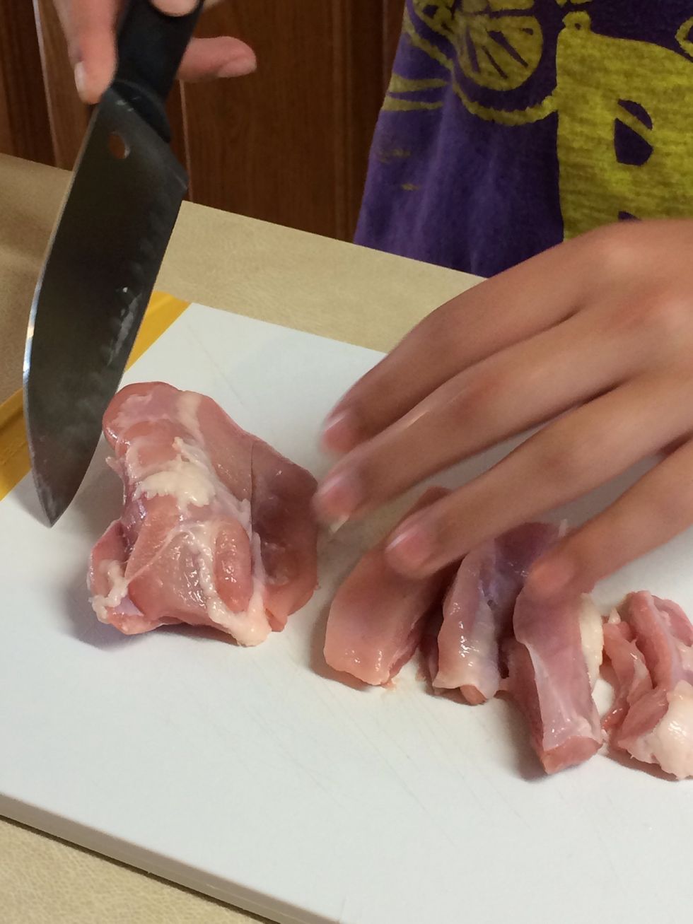 Second, you have to cut the chicken into slices. (Making sure you swap chopping boards)