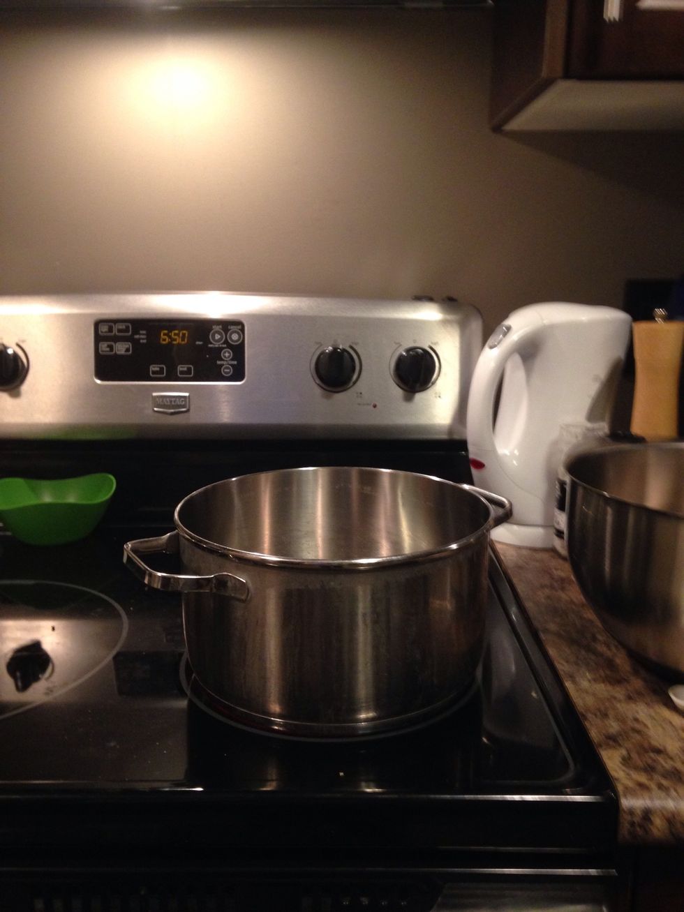 Second you put the pot on to the stove then turn on the stove to medium heat.