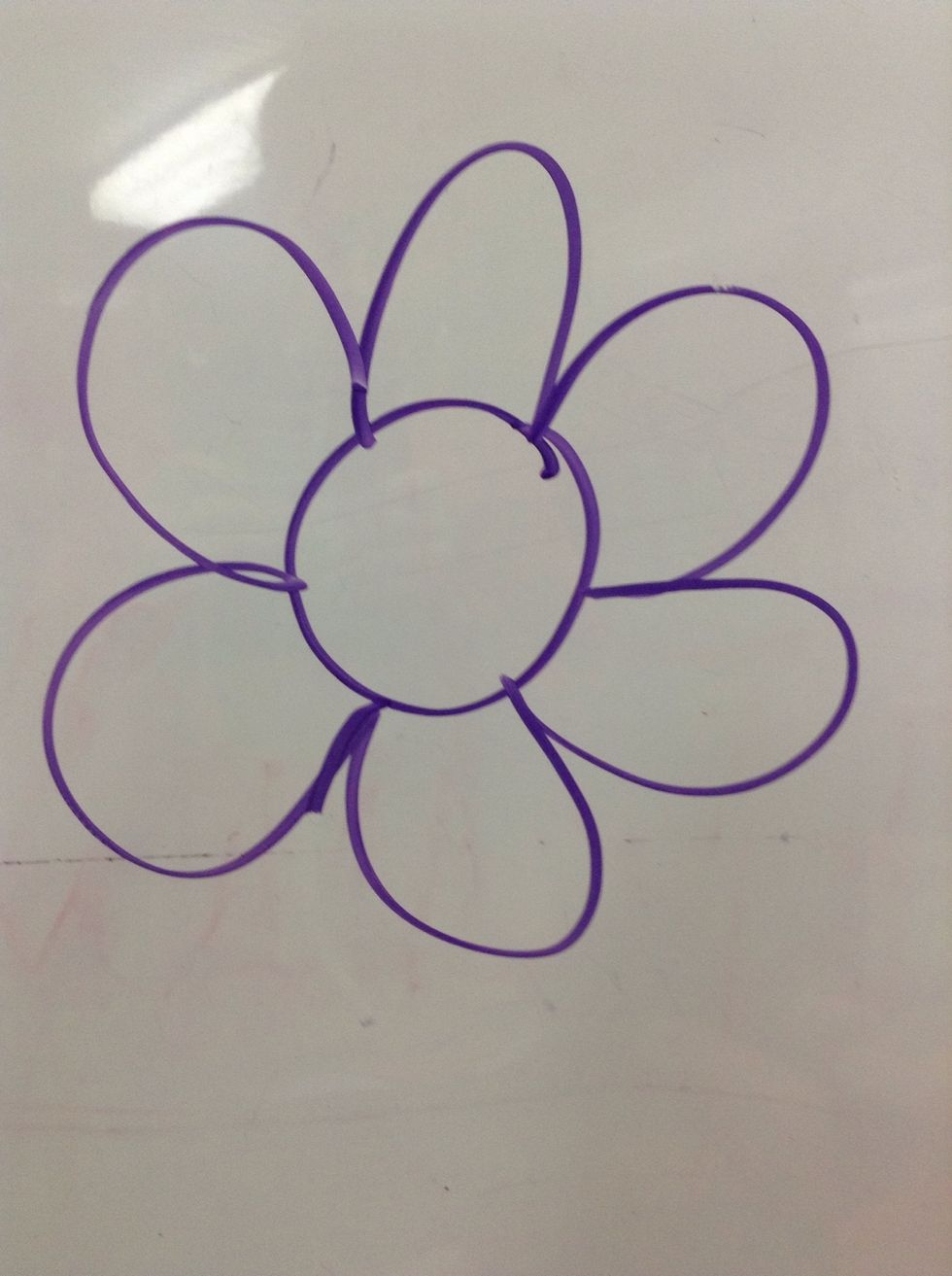 Secondly you have to draw the petals on the circle part of the flower.