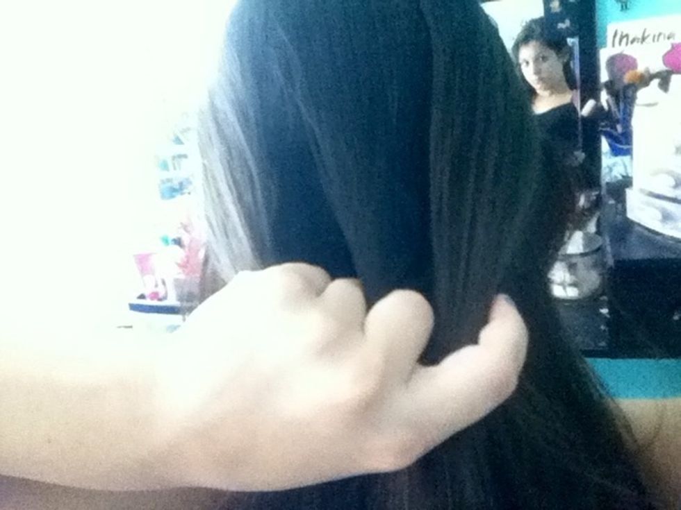 Section of the crown of your hair and pull to pack of the head. Separate into 3 sections.