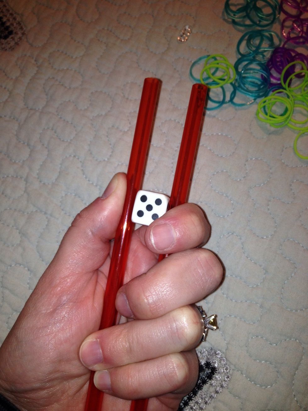 Secure eraser between straws and hold in one hand.