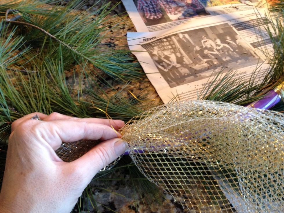Secure it to the back of the hoop with a twist and tie of the wire.