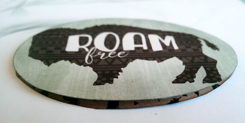 Secure it to the top of the Feather Oval. This will give it a little dimension on the tag.