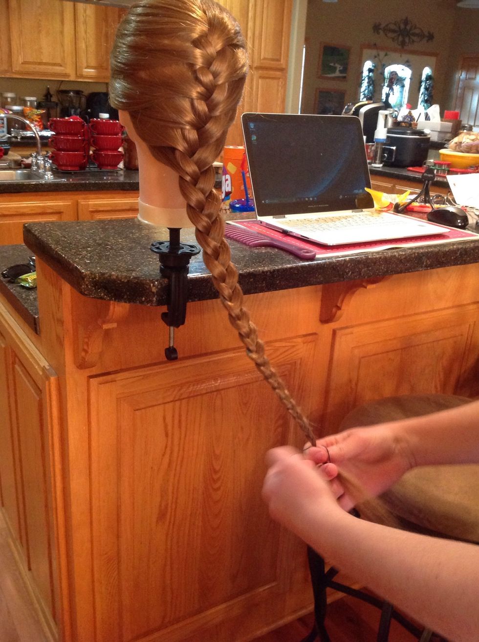 Secure the braid by wrapping a hair elastic around the end.