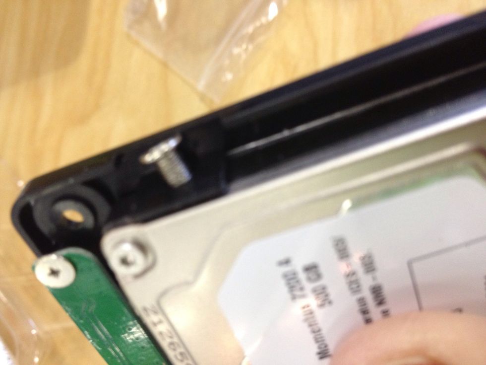 Secure the drive into the tray of the case.