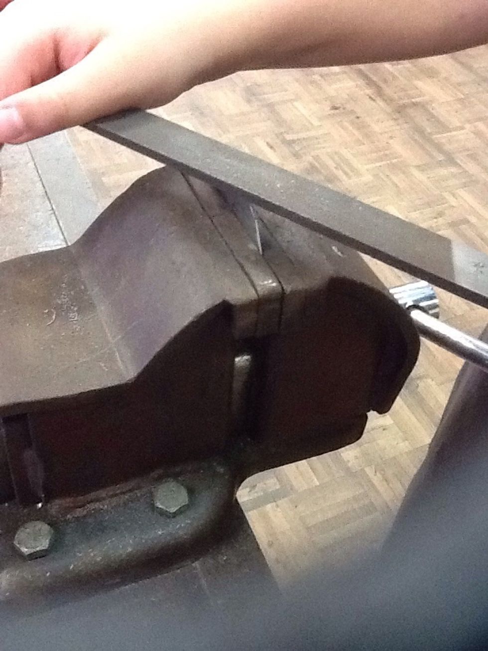Secure the metal into the vice and file the metal so it has no sharp edges