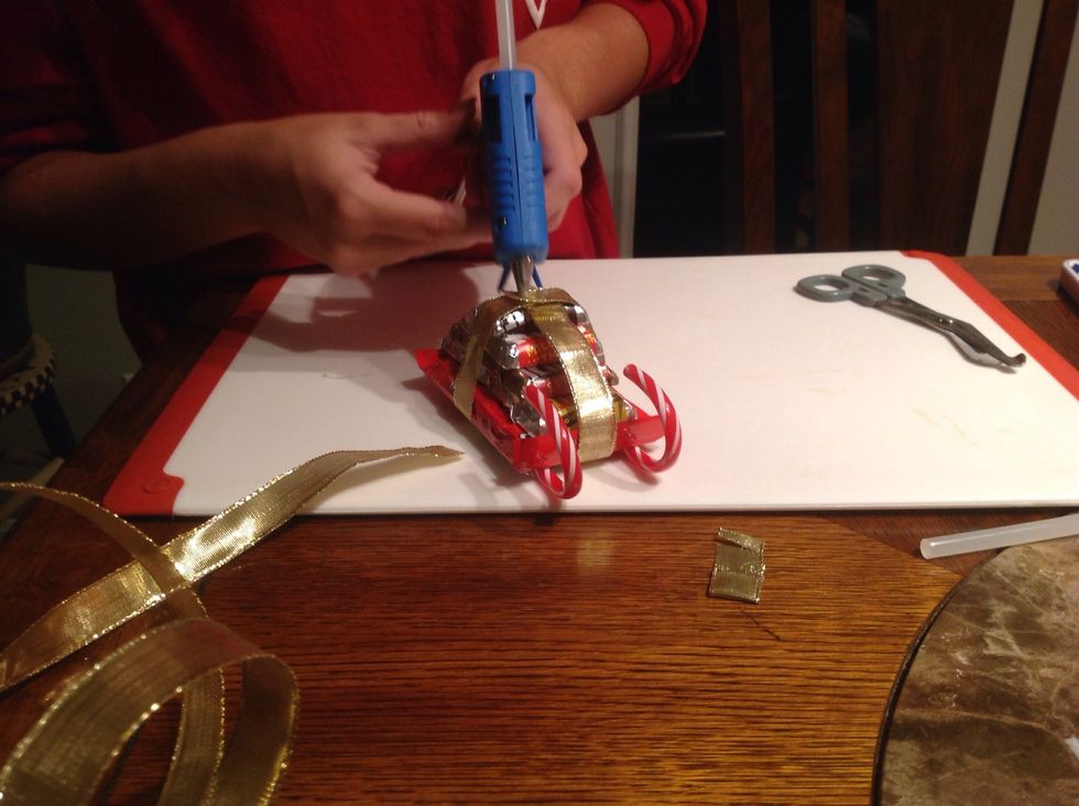 Secure the ribbon with hot glue on the top.