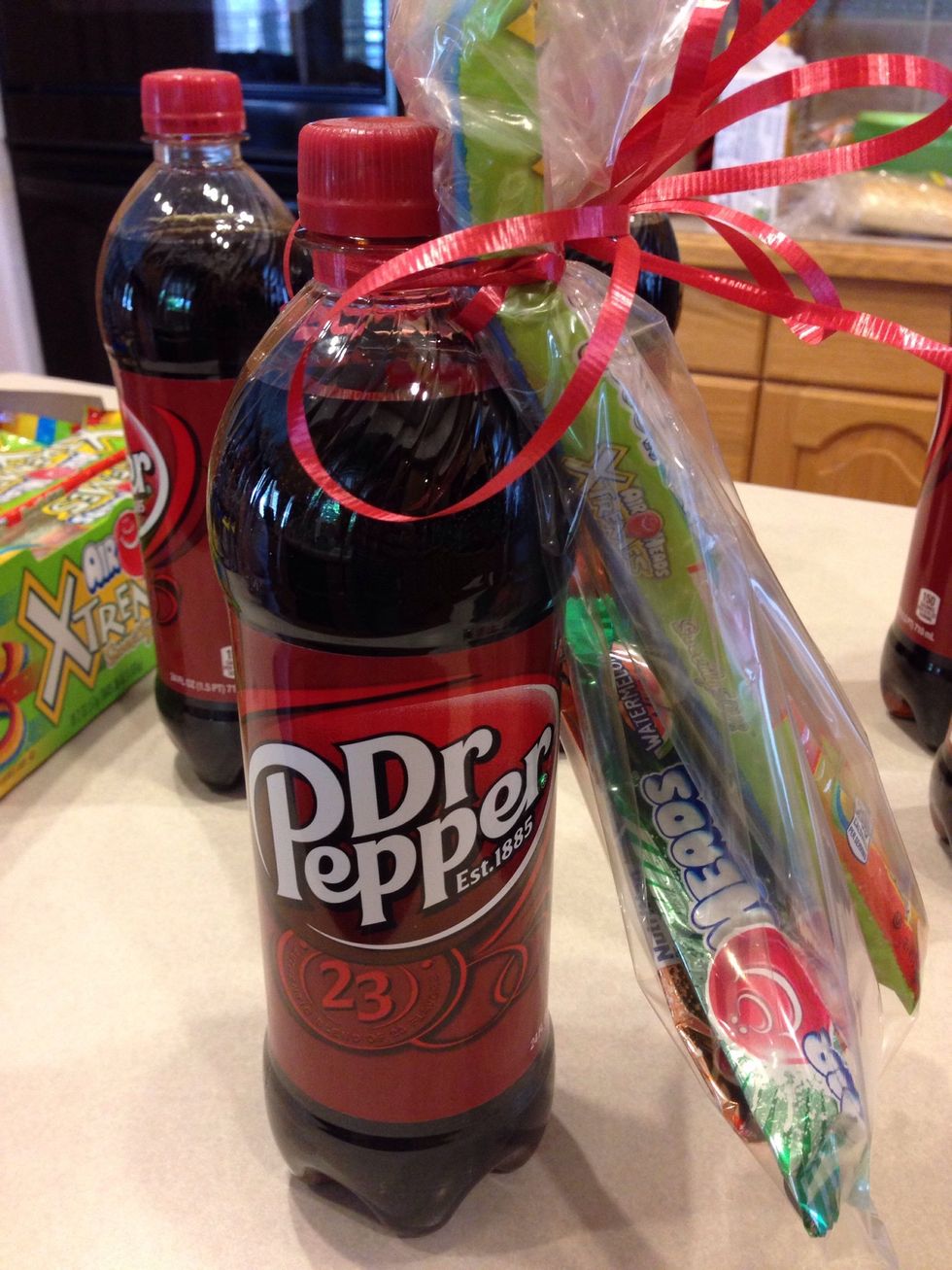 Secure them by wrapping the curling ribbon around the clear bag and neck of the soda bottle several times. Then add a loopy bow.