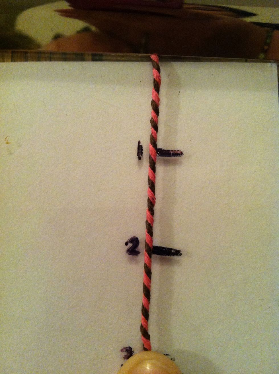 Secure with clipboard or safe pin and twist the cords around each other till you have a 3inch length.