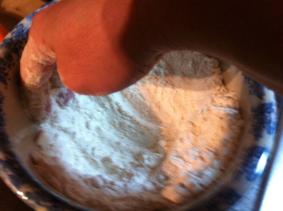 See how there is only small lumps? That's the butter. Now, push the mix up to side of bowl to make a well.