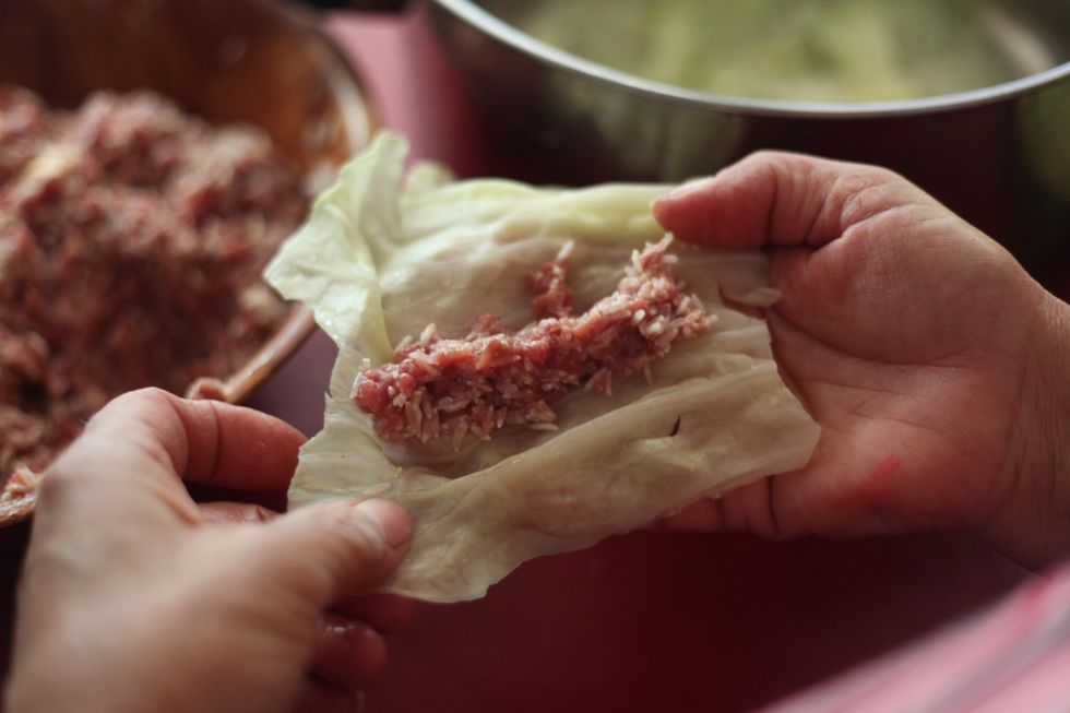 See! Now wash your hands as no gloves are on. Kids of today! Anyway, place the mix onto the cabbage leaf....