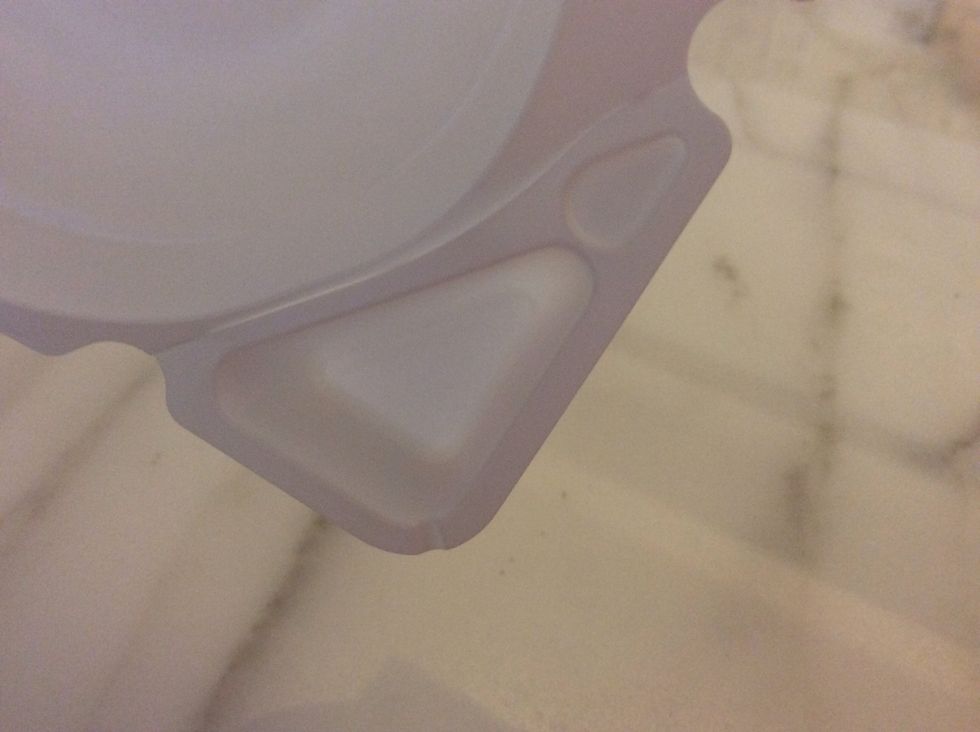 See that cut there? Or it might look like a line to u, anyway, pull that off. Use your scissors to cut it if you find it hard to break it away.