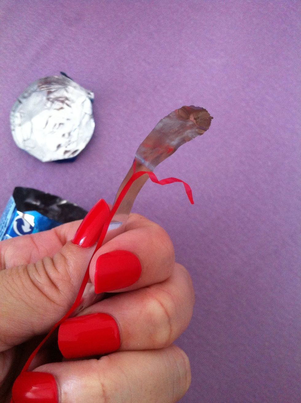 See the red ribbon? Try to pull it separated. The round part too. Is a little difficult when you have those fake red nails. \ud83d\ude12