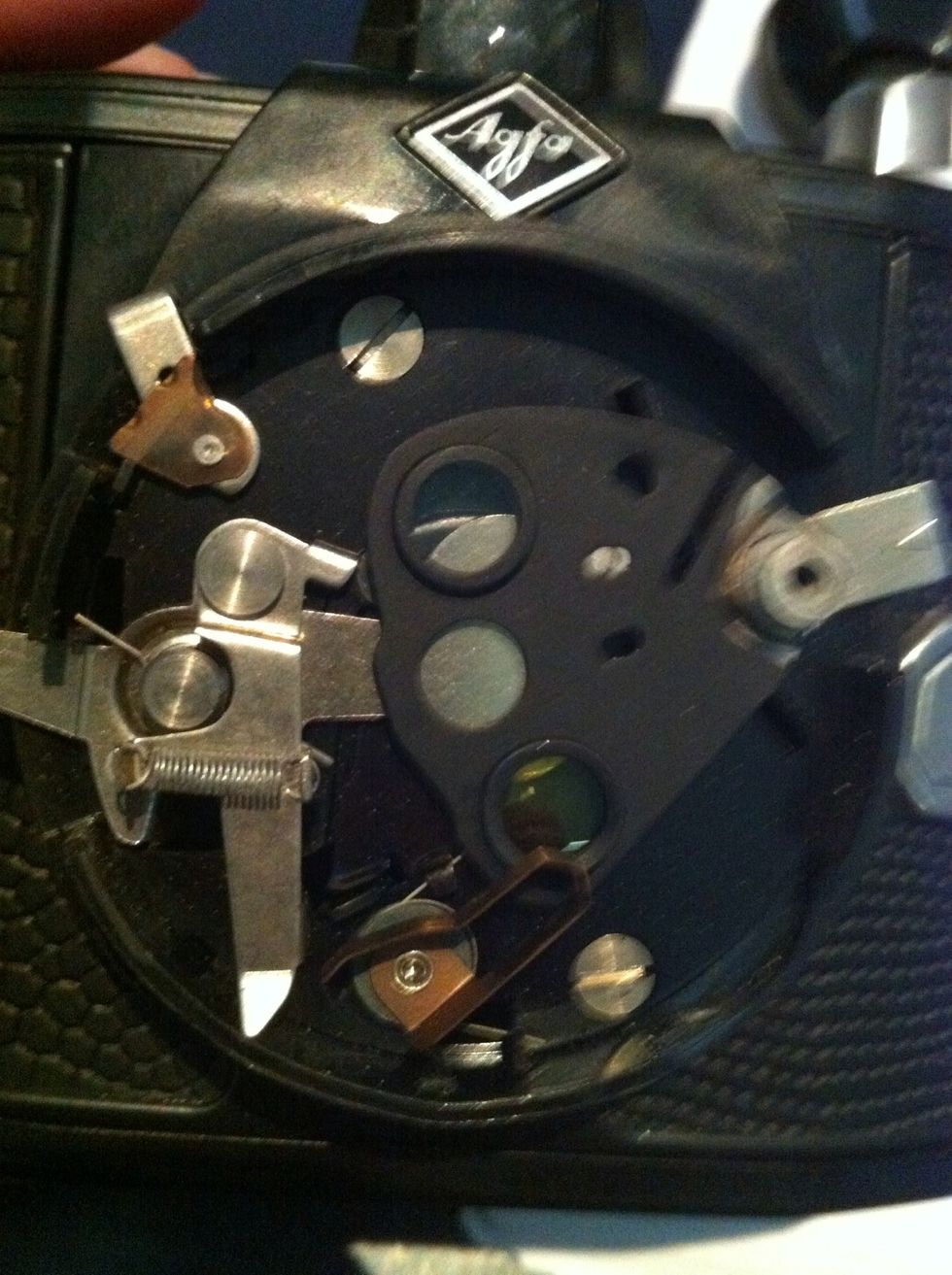 See the screws on the top and bottom?? Unscrew those.. Lever the shutter plate off gently BUT!!! ...