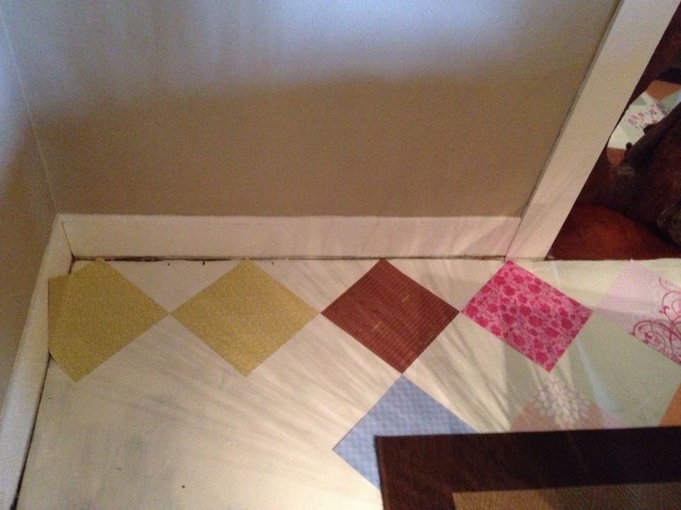 See the white. (Didn't get a pic of just white).  Using the wall as a straight edge, adhere 12x12 paper to floor. make sure to match corners as perfectly as possible.