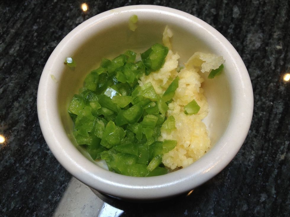 Seed and finely chop the jalape\u00f1os. If you like it spicy, use 2. If you like it moderately spicy, 1 will do the trick. Also, peel and chop or press the garlic cloves.