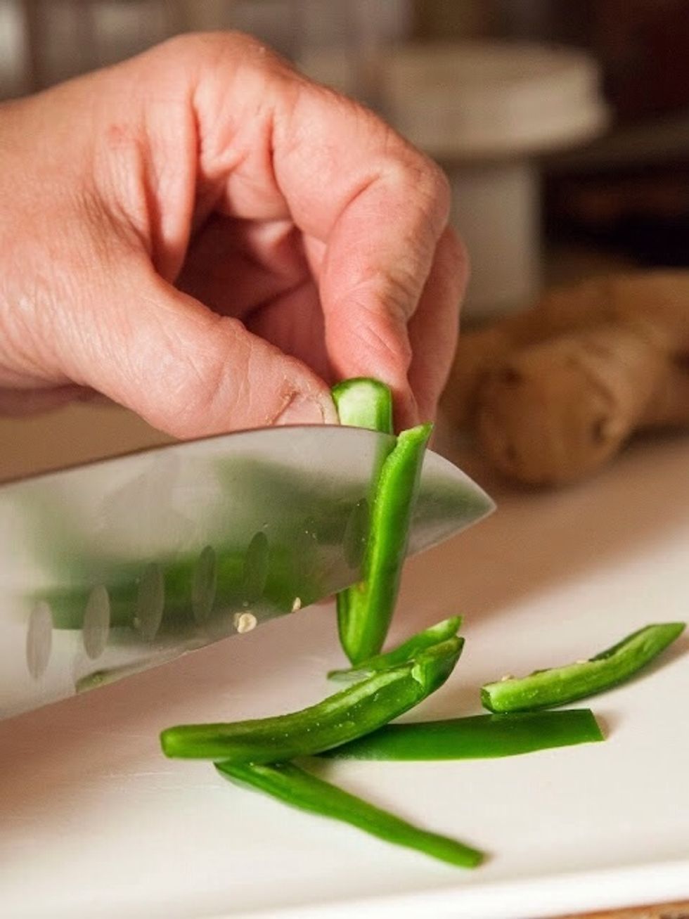 Seed and slice the serrano chilies.(I do this just in case I'm going to be serving this to people who might be concerned about heat. If you like the spicy, just toss in the whole serrano chilies.)
